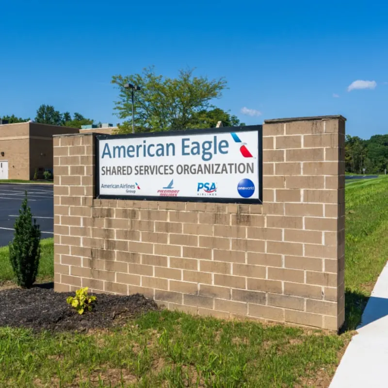 Sign in front of the Corporate offices for American Eagle Shared Services Organization including American Airlines Group, Piedmont Airlines, PSA Airlines, and OneWorld