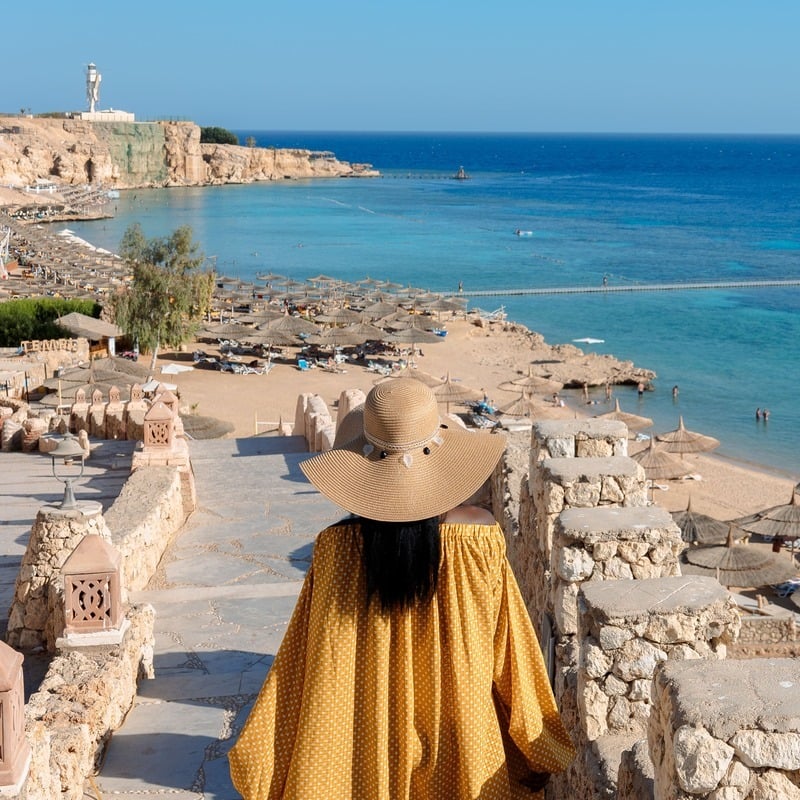 A Young Woman Wearing A Yellow Dress In Sinai Egypt By The Beach