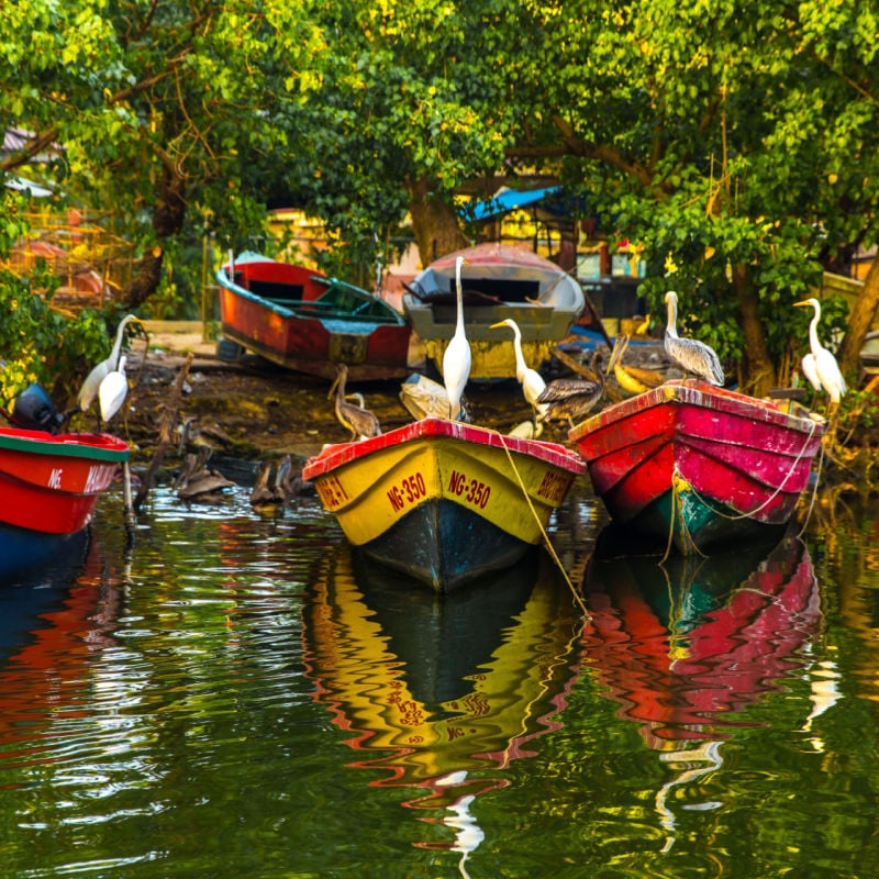 several colorful boats sit in the water in Negril Jamaica
