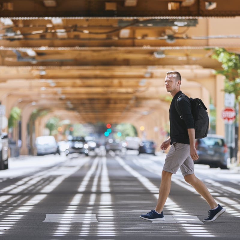 man walking across the street in chicago