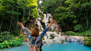 Woman in front of Kuang Si waterfalls in Laos