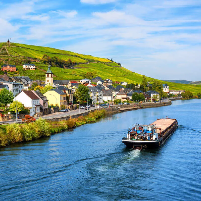 A Boat Traveling Up The Moselle River In Rural Luxembourg, A Small Country In Western Europe