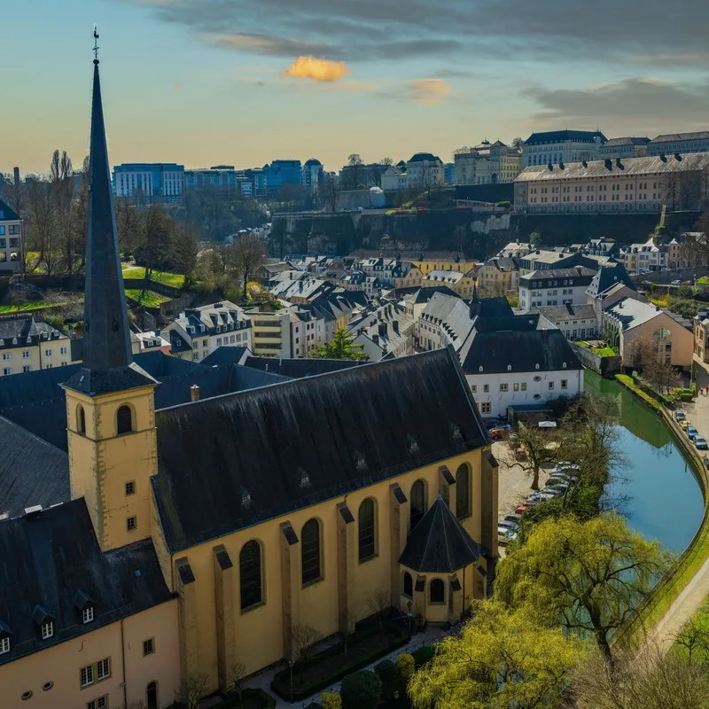 A Historic Church WIth A Spire In The Grund District Of Luxembourg City, Capital Of Luxembourg, Western Europe