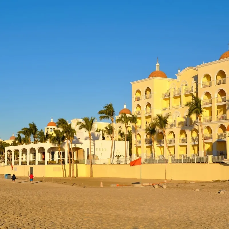 A Sandy Beachfront Lined With Resorts In Los Cabos, Mexico