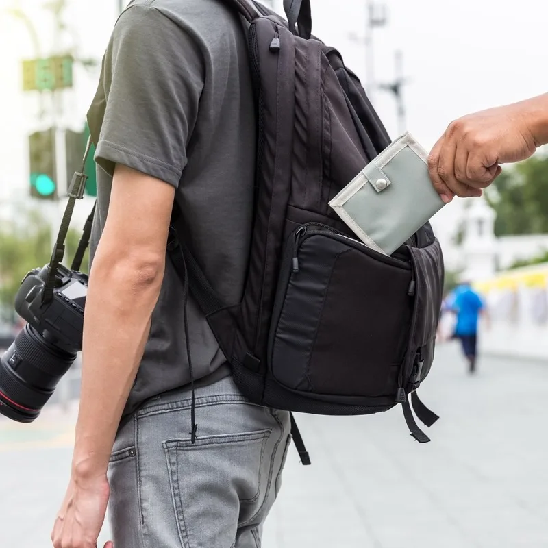 A Tourist Carrying A Camera And Backpack Having His Wallet Stolen Unbeknownst To Him, Pickpocketing In Europe