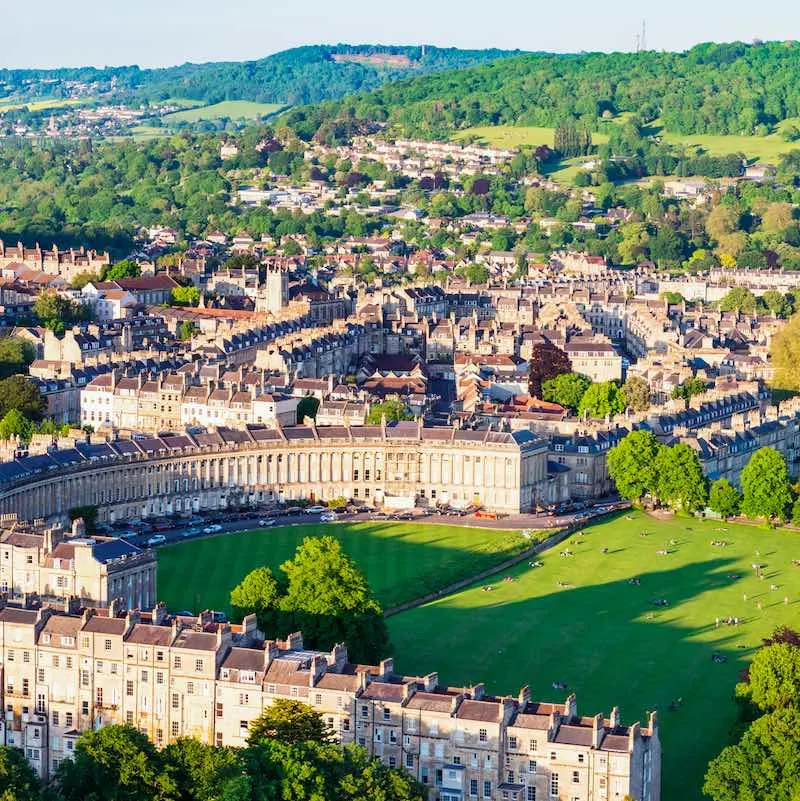 sunny day over historical castles in Bath, England surrounded by greenery
