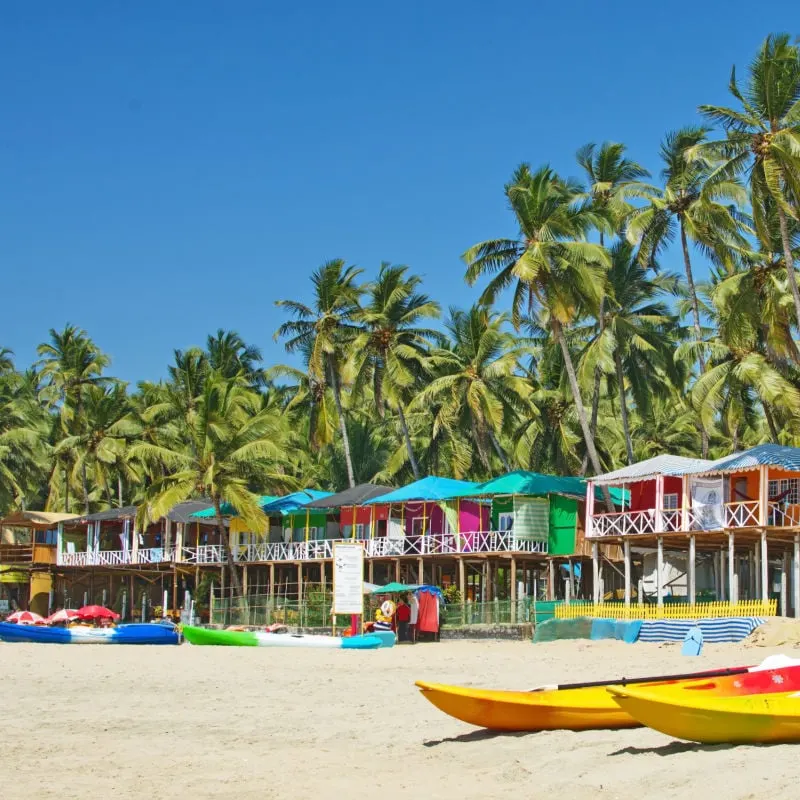 beach and colorful homes in goa india