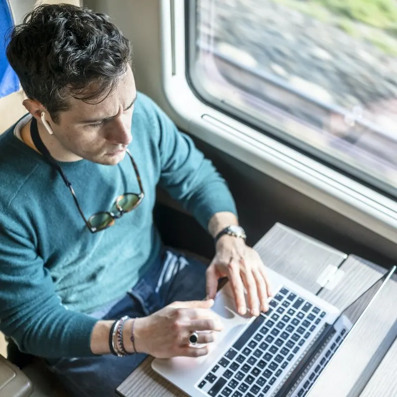 man working with laptop in train