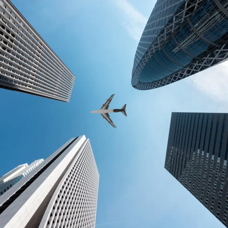 city buildings flying airplane