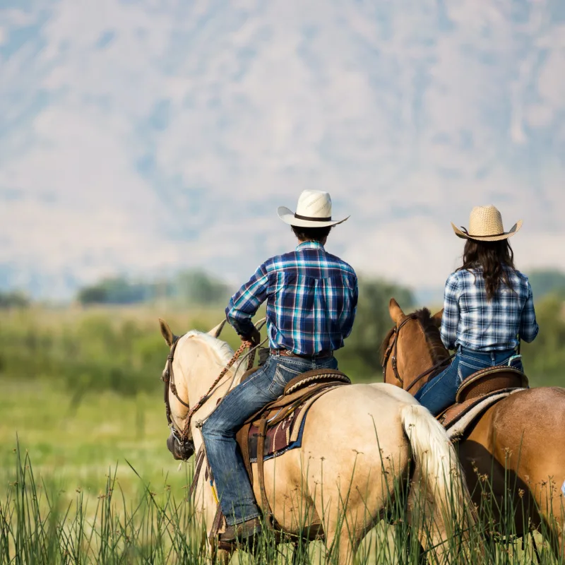 cowboy couple on horses, travel west