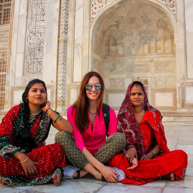 female tourist and two local indian women at a temple