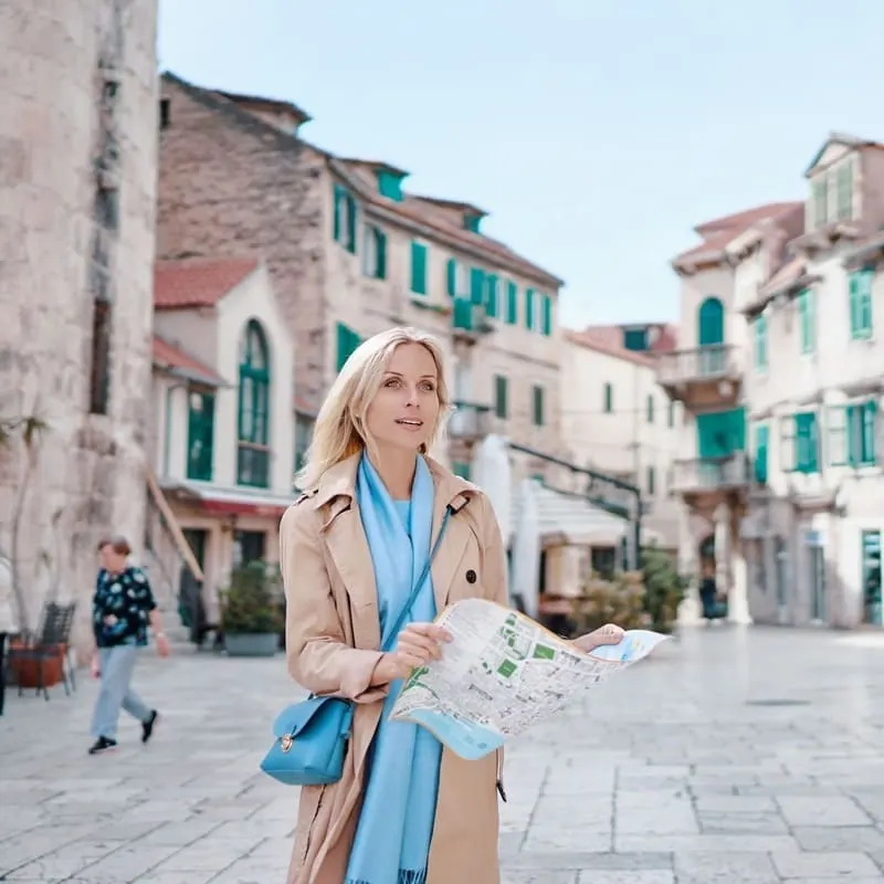 Female Tourist Holding Up A Map In Split, Croatia