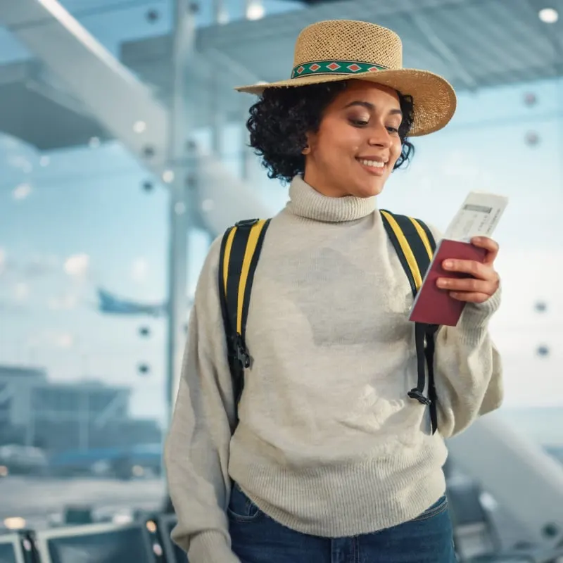 female traveler with passport at airport terminal