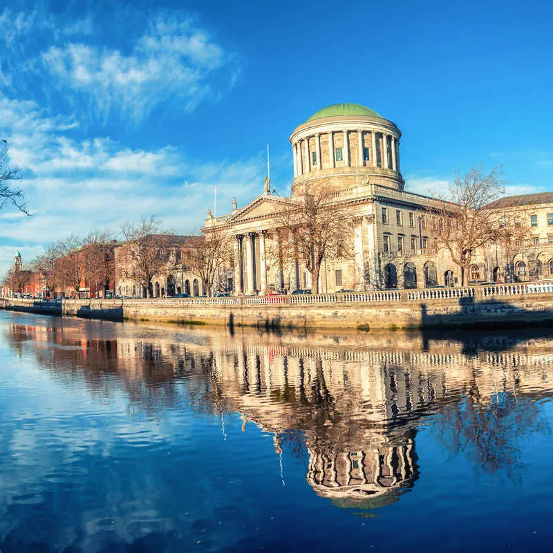 Four Courts Building Reflected On The Water Of The River Liffey In Central Dublin, Capital City Of Ireland, Europe