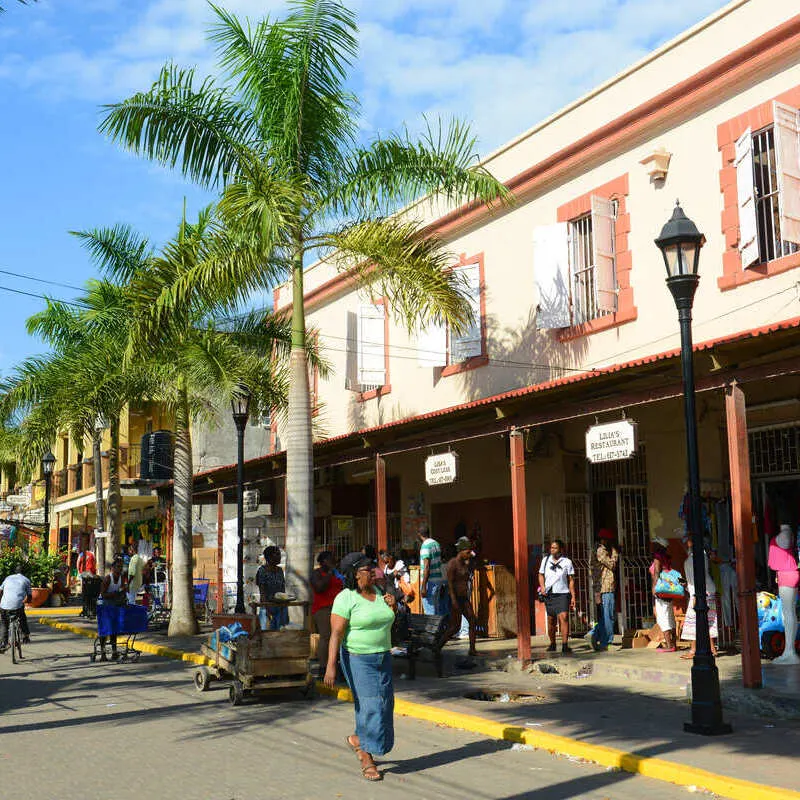 Jamaicans And Tourists Walking Down A Busy Shopping Street In Falmouth, Jamaica