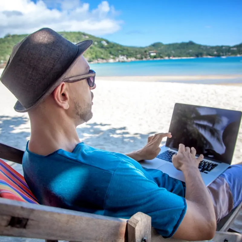 Male Digital Nomad Working From The Bech, Unspecified Location