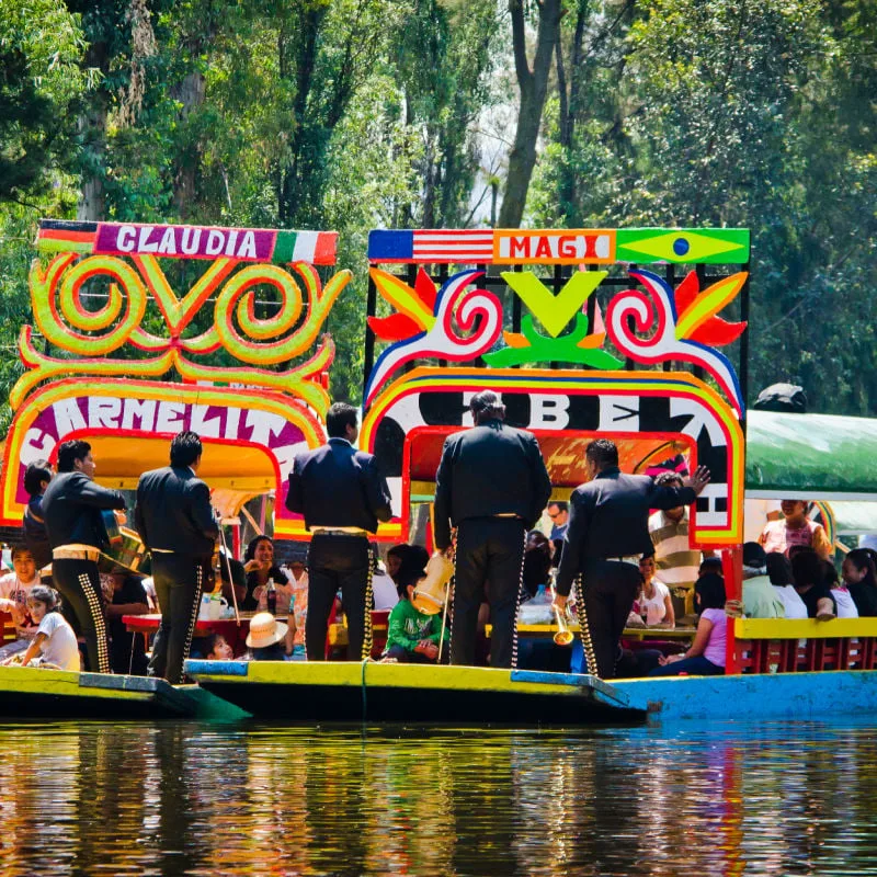 mariachis performing on a boat in xochimilco