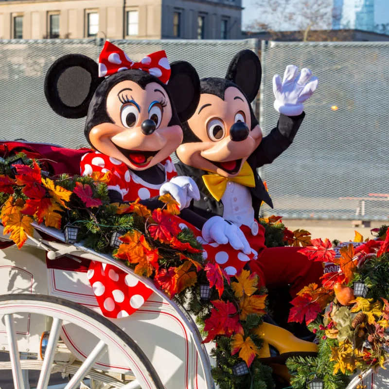 Mickey Mouse and Minnie Mouse in a parade car at Walt Disney World