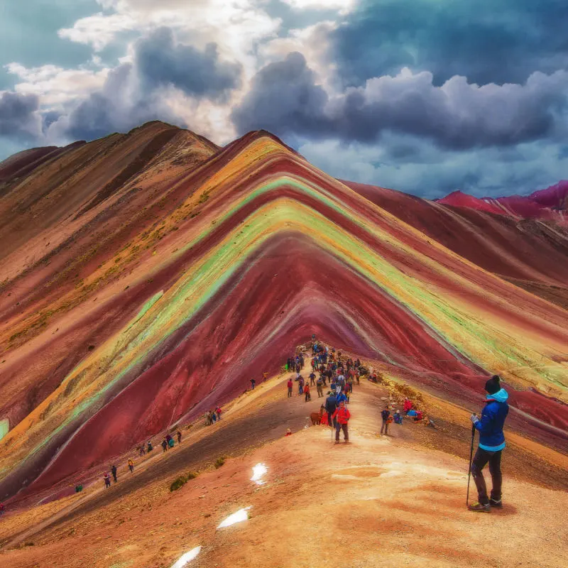 hikers and the rainbow mountains in peru