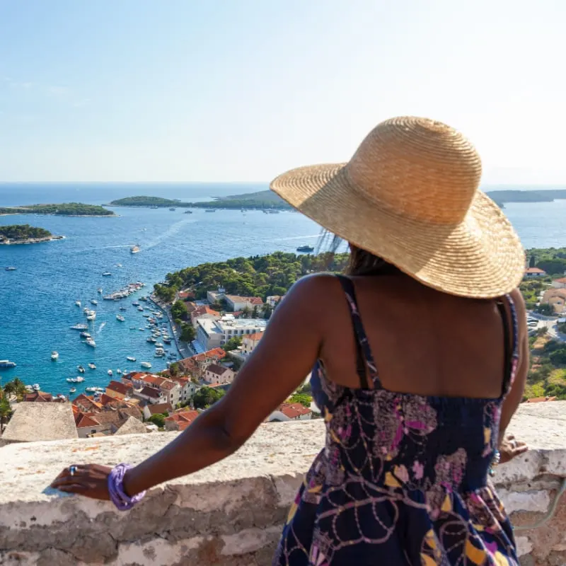 Solo female traveler looking out at Hvar, Croatia