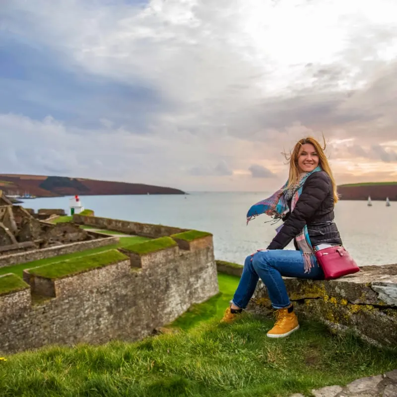 Solo female traveler woman on the castle walls in Ireland