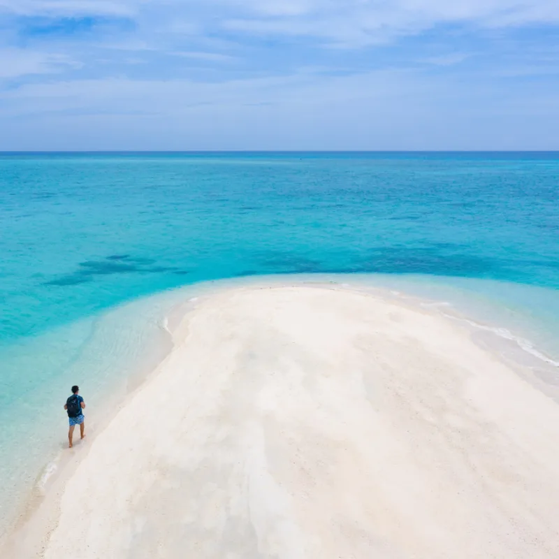 solo traveler on remote beach