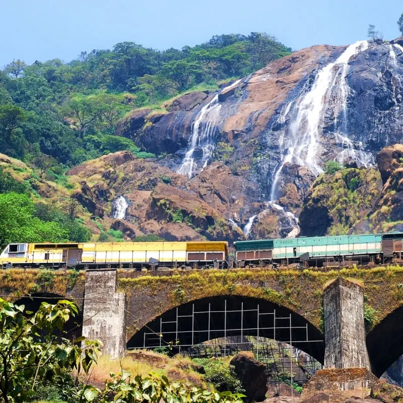 train in india passing waterfalls