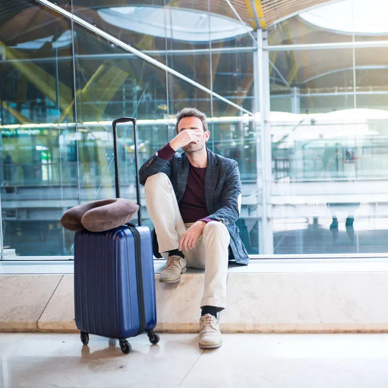 Traveler Upset At The Airport After Having A Flight Cancelled Or Other Flight Disruption