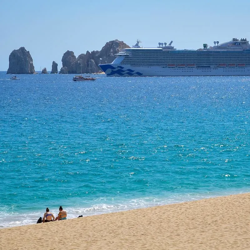 Two Women In A Mexican Beach Observing Princess Cruise Vessel In Mexico, Pacific Coast