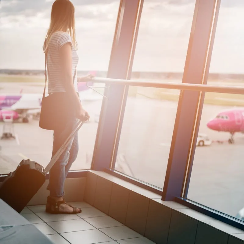 woman looking out of airport terminal