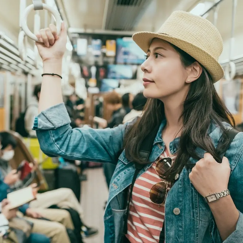 woman traveling on subway train in japan