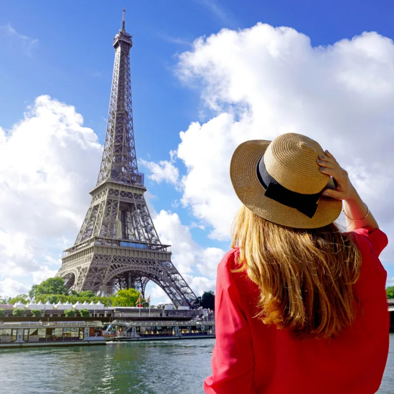 woman with hat in front of Eiffel Tower Paris copy