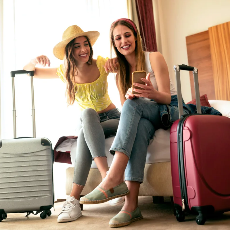 Women in a hotel room with luggage