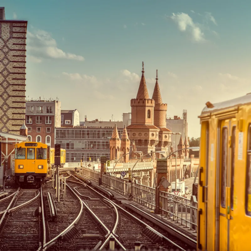 Yellow UBauhn Trains in Germany with Berlin Skyline View