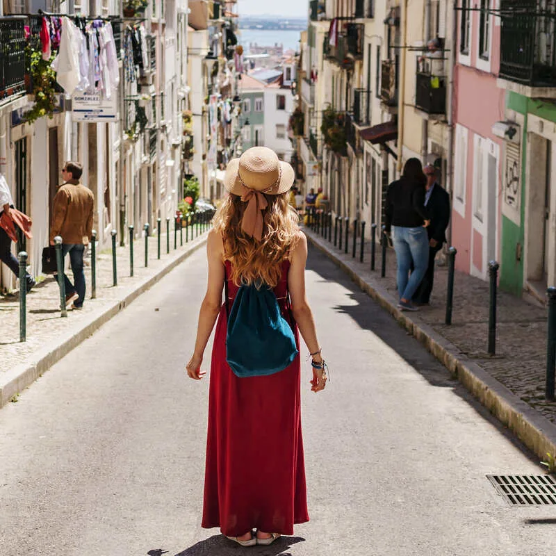 Young Female Traveler Walking A Street In Spain